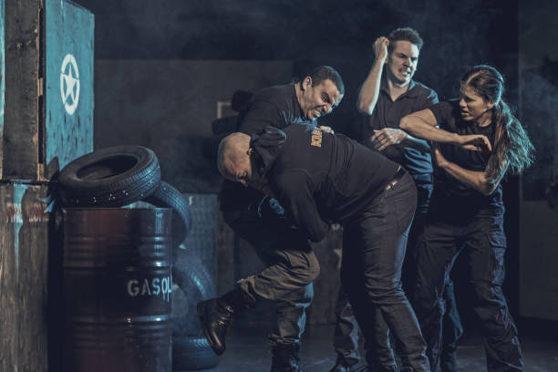 istock Krav Maga fighting group training in dark indoor urban setting 902280034