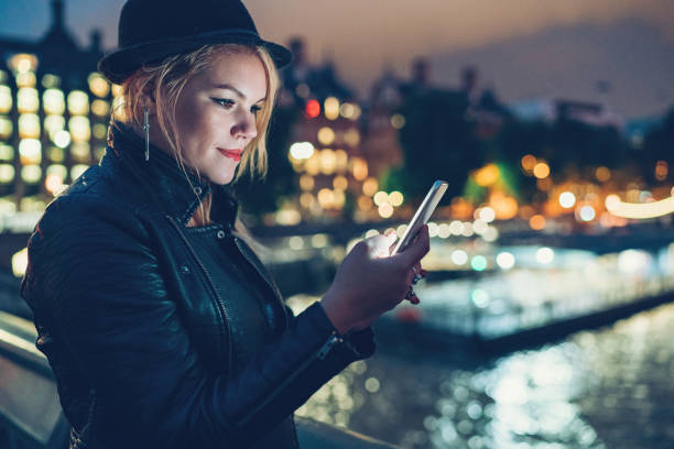 istock Young woman texting at night 902286336