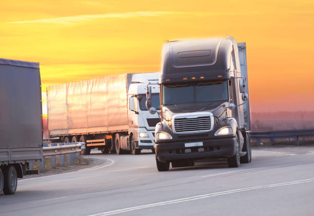 istock trucks goes on highway on sunset 902287904