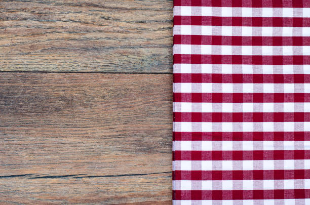 istock Tablecloth in white and red cage on wooden table 902290488