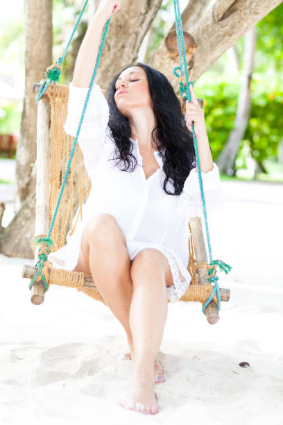 istock Woman relaxing in hommack on the beach 902293714