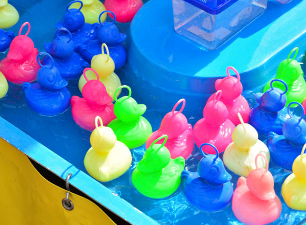 istock Multicolored ducks game for children at the fair 902293848
