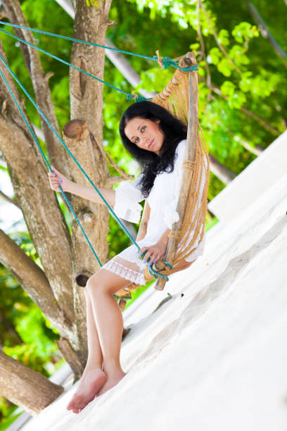 istock Woman relaxing in hommack on the beach 902297642