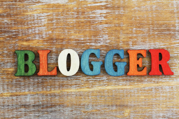 istock Blogger written with colorful letters on rustic wooden surface 902306778