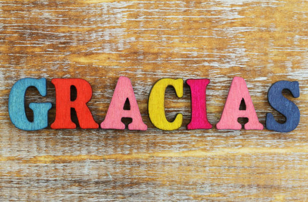 istock Gracias (which means thank you in Spanish) written with colorful letters on rustic wooden surface 902307128