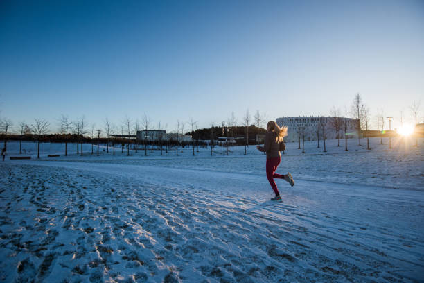 istock Blondie woman running at winter sunset. 902307160