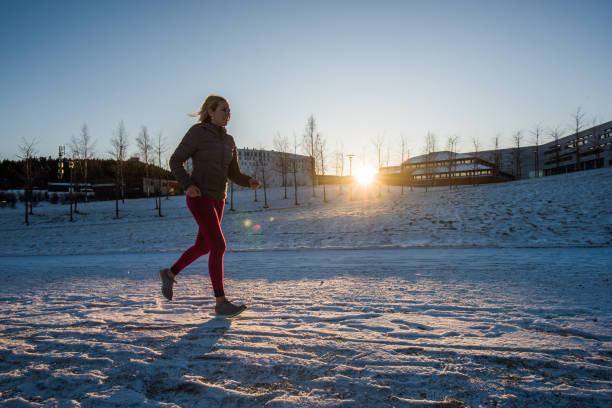 istock Women runner at sunset in winter day. 902307484