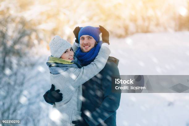 Happy Young Couple In Winter Park Laughing And Having Fun Family Outdoors Stock Photo - Download Image Now