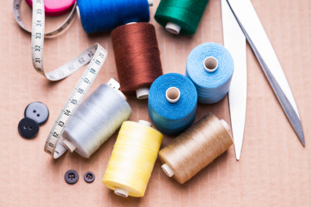 istock Pile of colorful spools of thread, scissors, buttons and measuring meter 902313312