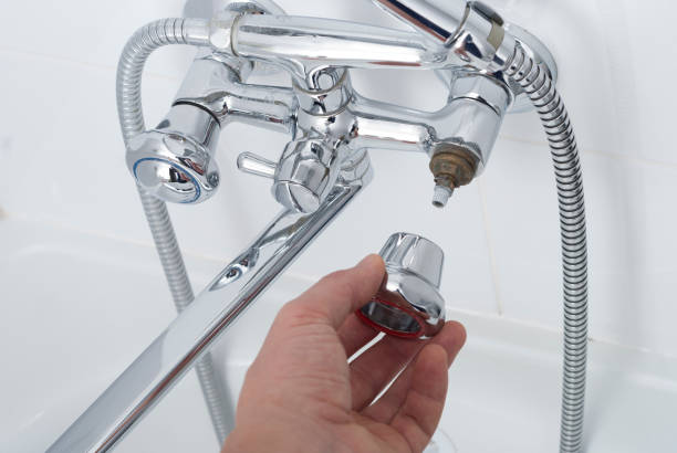 istock plumber repairs the faucet 902316876