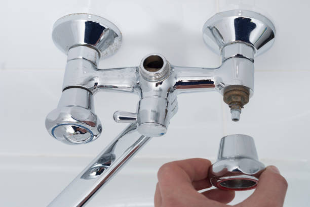 istock plumber repairs the faucet 902316902