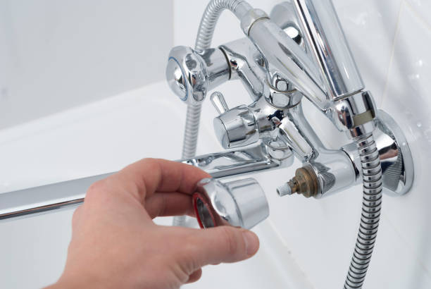 istock plumber repairs the faucet 902316922