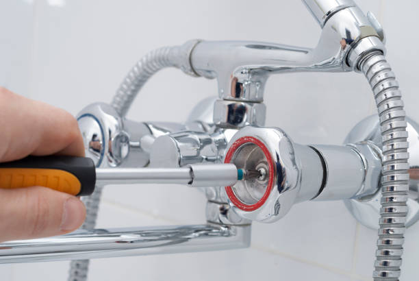 istock plumber repairs the faucet 902316946