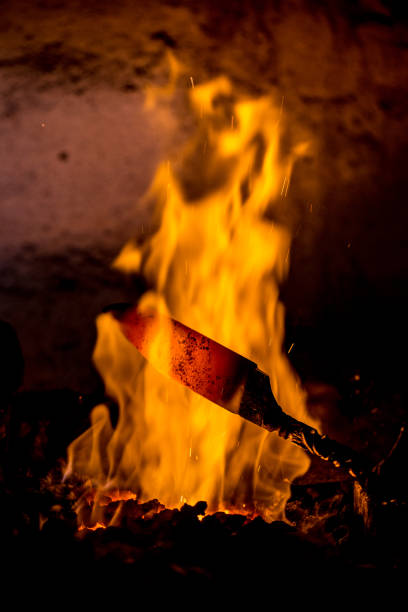 Close-up of Blacksmith Tempering a Knife.