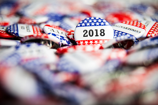 A 2018 Election Vote button on a pile of other buttons