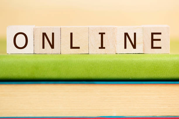 istock Online word built with letter cubes on green book 902323724