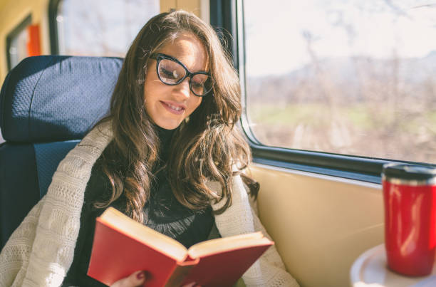 istock Young sad woman looking through the train window. 902323838