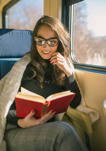 istock Young sad woman looking through the train window. 902325912