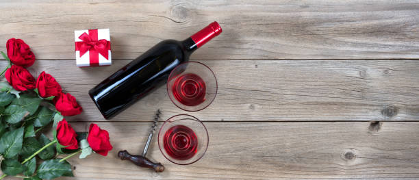 istock Red Wine for Valentines Date on rustic wooden background 902329566