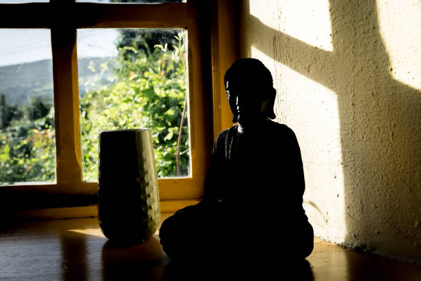 istock Vase and Buddha sitting on window sill 902331692