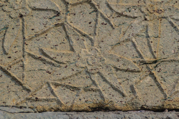 istock Beautiful background with flowers carving on the old stone. 902341278