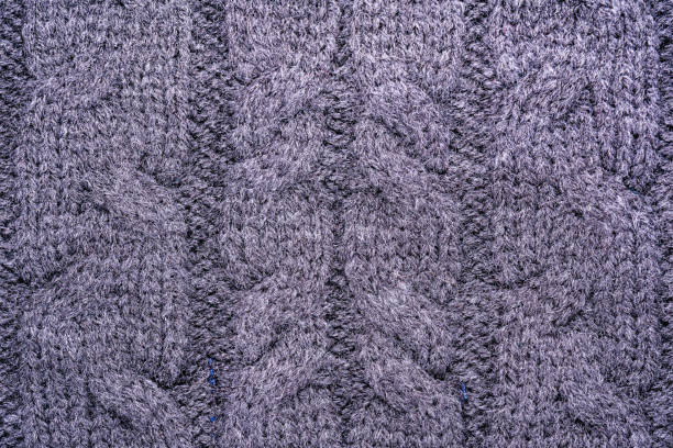 istock texture of the surface of a knitted woolen fabric with a pigtail pattern, abstract background 902344444