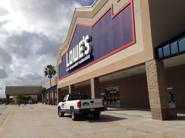 Lowe's home improvement storefront West Palm Beach, USA - 10/24/2017: Lowe's home improvement storefront. Lowe's operates one of the major home improvement business enterprises in the USA. This image shows a Lowe's storefront with one of their Lowe's branded rental pickup trucks parked in front. Several shoppers are visible walking away from the store in the distance. lowes home improvement store stock pictures, royalty-free photos & images