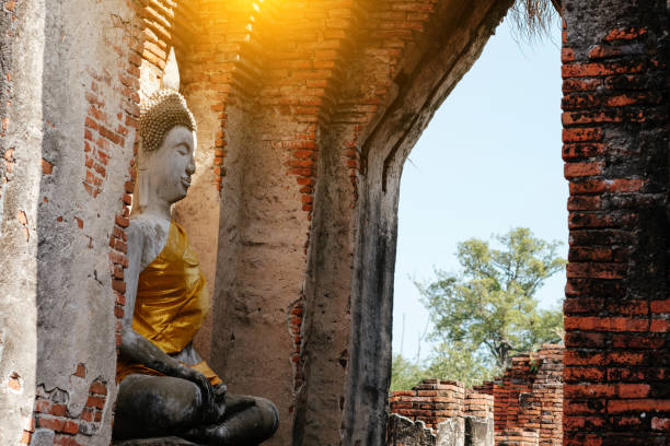 istock Ancient Buddha and old brick wall on ancient monuments that are over 200 years old. Wat Nakhon Luang Tample,Prasat Nakhon Luang public domain or treasure of Buddhism in  Ayutthaya, Thailand 902369336