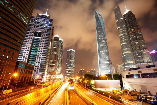 istock the light trails on the modern building background in shanghai china 902378102