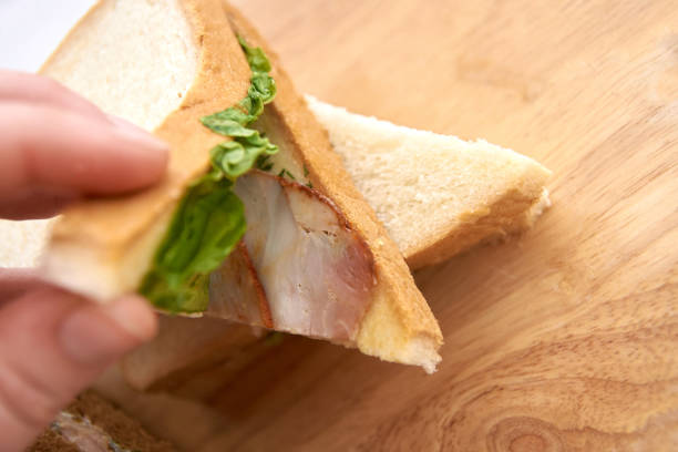 istock Sandwich with ham. Green salad 902379072