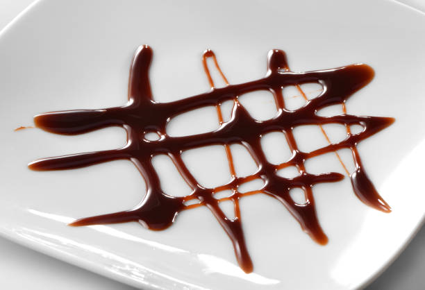 istock chocolate sauce decoration on white plate 902384864