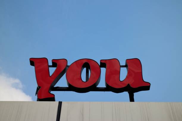 istock Red 'You' Sign on Cloudy Blue Sky 902387574