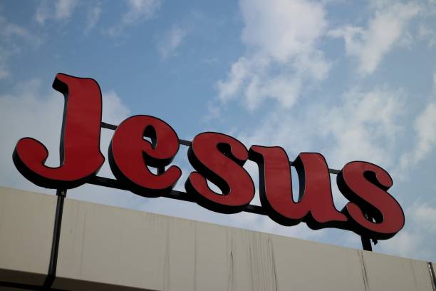 istock Red Jesus Sign on Cloudy Blue Sky 902387604