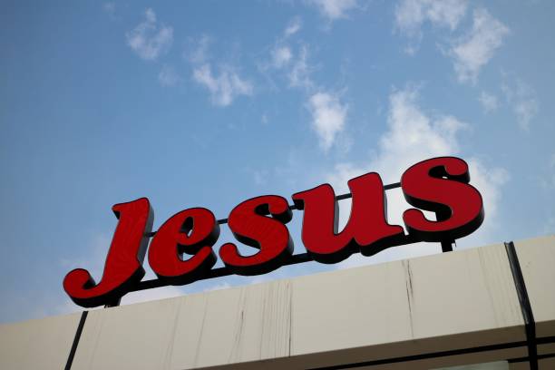 istock Tilted Jesus Sign on Cloudy Blue Sky 902387850
