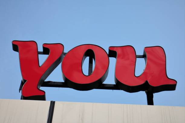 Red 'You' Sign on Clear Blue Sky