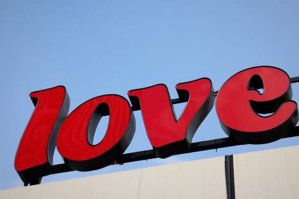istock Red 'Love' Sign on Clear Blue Sky 902387900