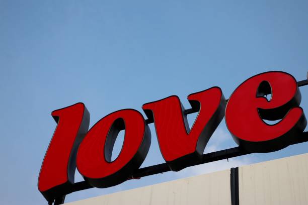 istock Red 'Love' Sign on Clear Blue Sky 902388080