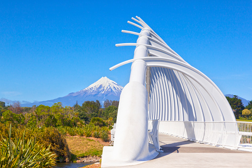 31 October 2012: New Plymouth, New Zealand - Te Rewa Rewa Bridge, New Plymouth, Taranaki Region, New Zealand, and Mount Taranaki on a clear sunny day. This is the most photographed bridge in New Zealand.