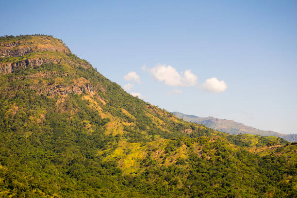 istock beautiful green mountains/Hills with blue sky background. 902394040