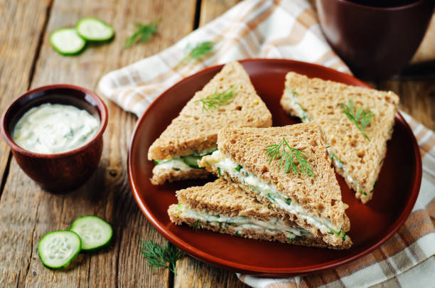 istock Cream cheese dill cucumber english tea sandwiches 902397408