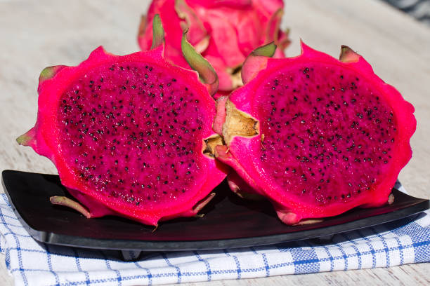 istock Ripe red pitahaya fruit with half. Dragon fruit . Island Bali, Ubud, Indonesia 902401482