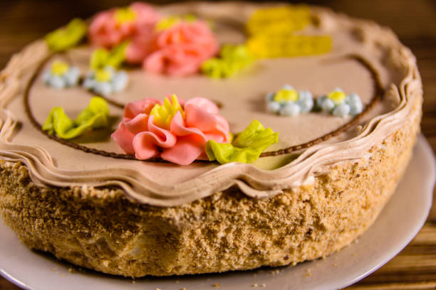 istock Kiev cake with cream on wooden table 902407332
