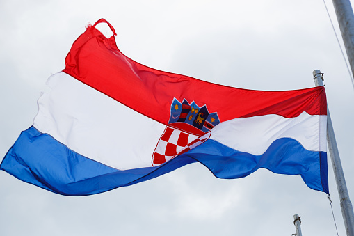 MAKARSKA,CROATIA - 18 JUNE,2017: National Croatian flag close up.Symbol of Croatia country & Dalmacia region in windy summer day.