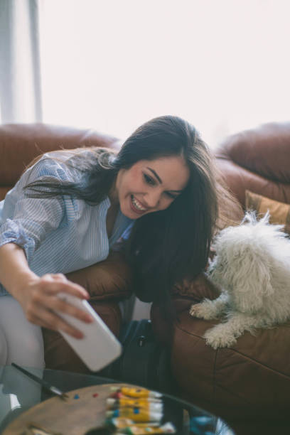 istock pretty young woman doing selfie with her dog 902414484