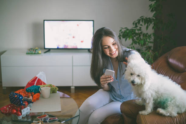 istock pretty young woman doing selfie with her dog 902415072