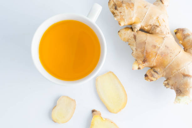 istock hot ginger tea ginger ale ginger beer in glass with ginger slice on white background 902415126