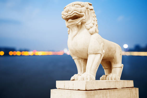 istock white stone lion sculpture in blue sunny sky 902420380