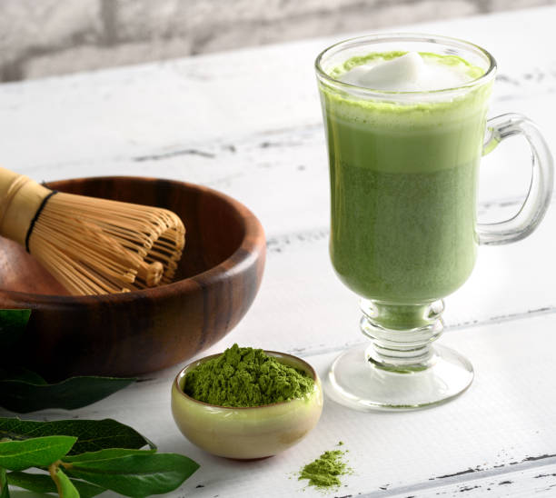 istock Matcha green tea latte beverage in glass cup on white background 902420536