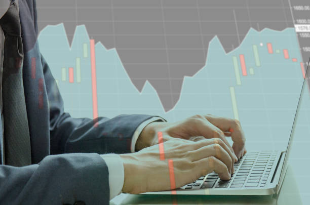 istock Double Exprosure of Business Man Typing Keyboard Laptop Hand with the Technical Graph for trading stock. Researching Process Global Strategy and Analyze market stock equity in blurred background. 902424780