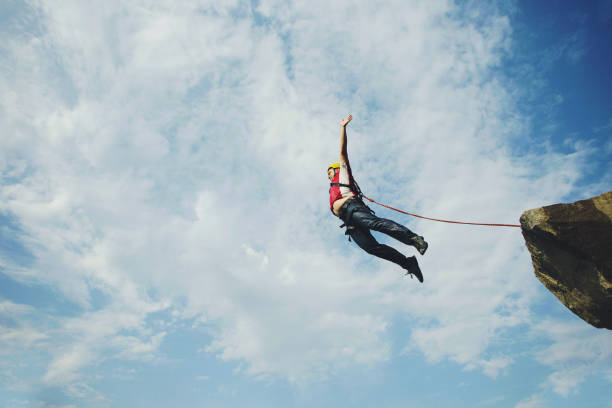 istock A man jumps into a canyon from a cliff. 902425710